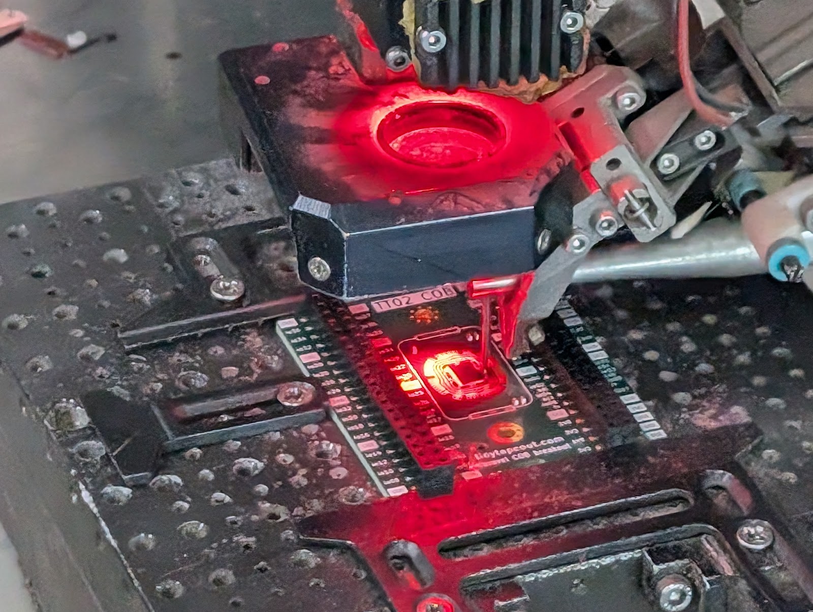 Wire bonding machine mid-bond on a die